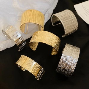 Luxurious water drop open cuff bracelets in gold and silver with textured metal finishes