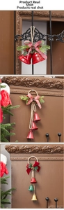 Close-up of vintage Christmas bells with pine needles, berries and rustic hemp rope