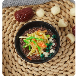 Close-up of a miniature bowl of soba noodles keychain with lifelike food details