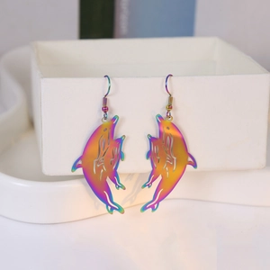 Macro detail of iridescent dolphin drop earrings with vibrant metallic rainbow gradient