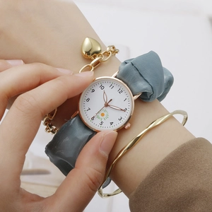 Women's quartz watch with daisy dial, blue silk strap and gold heart charm bracelet