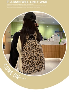 Detail of leopard print corduroy backpack featuring adjustable straps and top handle