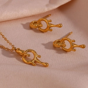 Lava style gold jewelry set with flowing metal pendant necklace and stud earrings