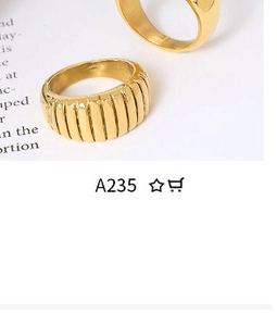 Detail of a gold minimalist ring featuring a vertical pleated texture on newsprint backdrop