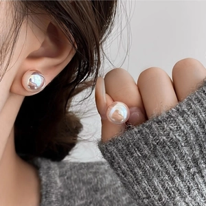Elegant rose gold sphere stud earrings on model for a sophisticated jewelry look