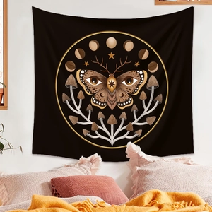 Detail of bohemian black butterfly tapestry with moon phases hanging over a bed