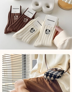 Detail of combed cotton ribbed mid-tube socks with cute dog embroidery and packaging