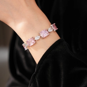 Detailed view of silver bracelet featuring pink rectangular stones and white zircons