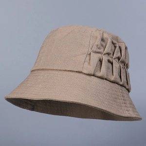 Close-up of khaki linen sun hat showing detailed accordion pleats and woven texture