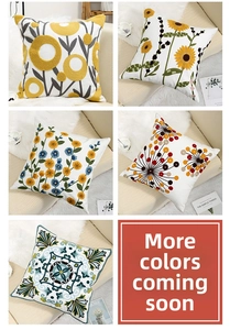 Detail of five floral and geometric embroidered cushion covers with textured tufted patterns