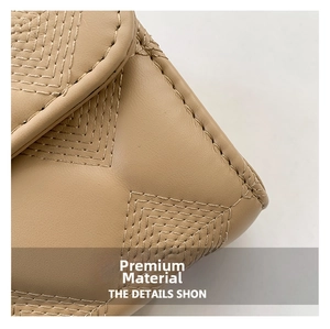 Close-up of khaki leather handbag showing premium quilted texture and precise stitching