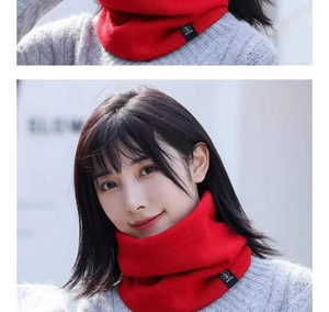 Detail of red knitted winter neck warmer with fleece lining and Winter brand label