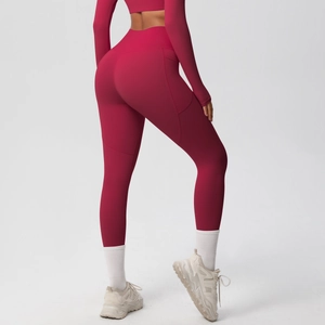 Detail view of high-waist yoga pants with side pocket and curved stitching in magenta