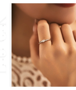 Detail of s925 sterling silver ring with marquise-cut zircon on female hand