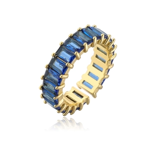 Detailed close-up of gold geometric open ring featuring channel-set blue baguette zircons