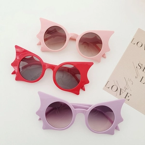 Kids bat-shaped butterfly sunglasses in pink, red, and purple with a plastic frame