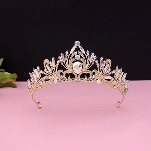 Detailed view of vintage gold tiara with drop-shaped rhinestones and baroque patterns