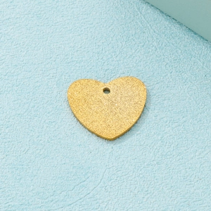 Golden heart-shaped pendant with a frosted texture surface on a light blue background