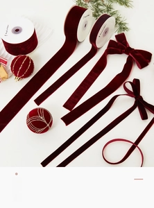 Macro detail of wine red velvet ribbons in various widths for festive gift wrapping