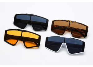 Flat lay of oversized sports sunglasses in black, tortoise, orange and white frames