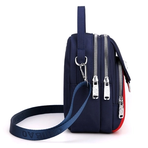 Dark blue multi-zipper nylon crossbody bag with adjustable strap and top handle