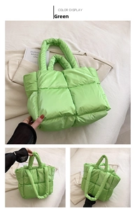 Detail of light green quilted puffer tote bag with soft padded handles and nylon texture