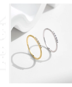 Detail of gold and silver beaded eternity rings with pavé cubic zirconia settings
