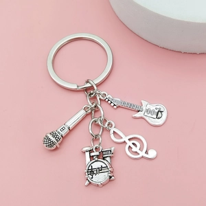 Silver music theme keychain featuring guitar, microphone, drums and musical note charms