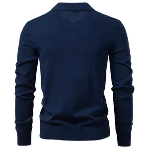 Macro detail of the navy blue knit polo sweater showing ribbed cuffs and hem texture