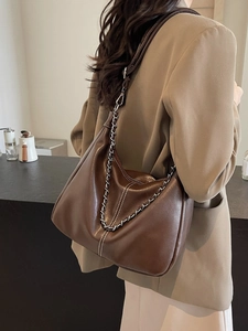 Retro dark brown leather underarm bag with white stitching and metal chain strap