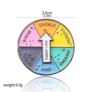 Detail view of rotating metal enamel pin with colorful sectors and white arrow pointer