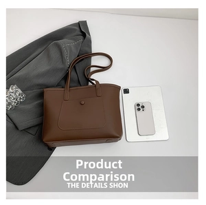 Detailed view of large brown faux leather tote bag with anti-wear base pads and front pocket