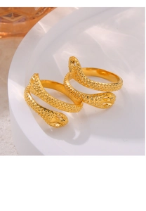 Detailed macro of golden snake-shaped wrap ring featuring textured granular embossing