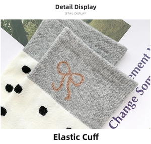 Detailed macro shot of elastic ribbed sock cuff with bow embroidery and polka dot patterns