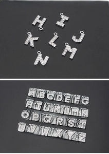 Detail of silver alloy 26 letters pendants with sparkling rhinestone inlay for DIY jewelry