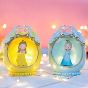 Illuminated resin princess figurines in yellow and blue eggs with angel wings decor
