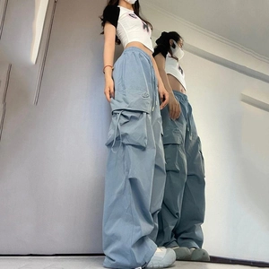Women's high waist blue cargo pants with wide leg and side pockets in street style