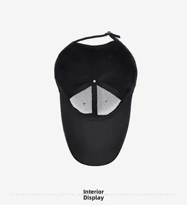 Detailed inside view of black cotton baseball cap showing seams and adjustable strap