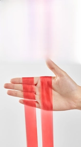 Strong red drawstring handle on garbage bag demonstrating heavy-duty lifting capacity