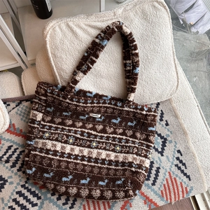Close-up of plush tote bag featuring vintage heart and floral patterns with Sozakka label