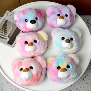 Detail view of multi-color tie-dye plush bear head bags arranged on a white round tray