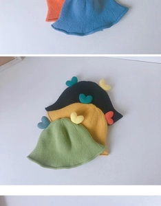 Close-up of knit texture and heart-shaped detail on colorful children bucket hats
