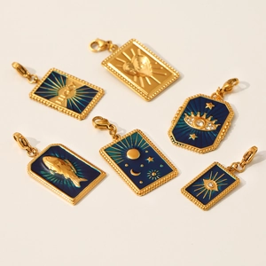 Flat lay of celestial stainless steel pendants with blue enamel stars and moon designs