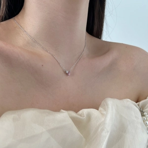 Close-up of S925 silver necklace with pink pear-shaped zircon and white diamond pendant
