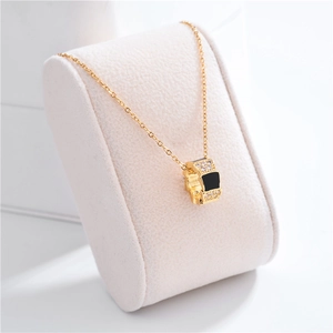 Rose gold snake chain necklace featuring a black shell cylinder pendant with pavé diamonds