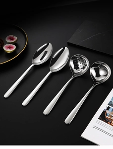 Close-up of premium 304 stainless steel serving spoons and ladles on a dark background