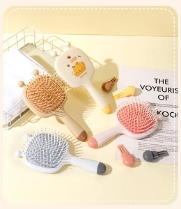 Close-up of colorful cartoon bee hairbrushes with soft bristles and air cushions