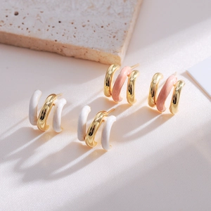 Detail of French vintage C-shaped earrings with colorful enamel and triple-ring design