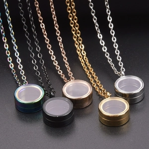 Detail of round stainless steel glass memory locket pendants in five metallic finishes