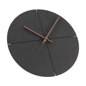 Detail view of a modern black wooden wall clock with brown hands and spliced dial design